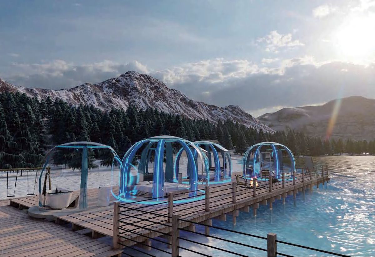 Transparent star-view glamping domes on wooden pier in winter landscape