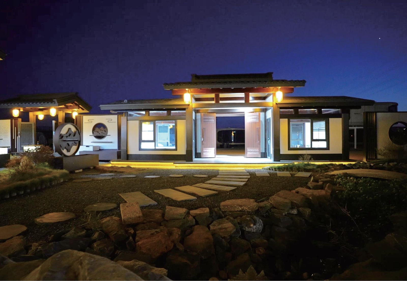Chinese-style prefab courtyard villa at night with warm lighting